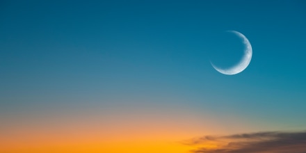 New moon or Ð¡rescent above ocean. Half Moon on bright evening sky, space for text